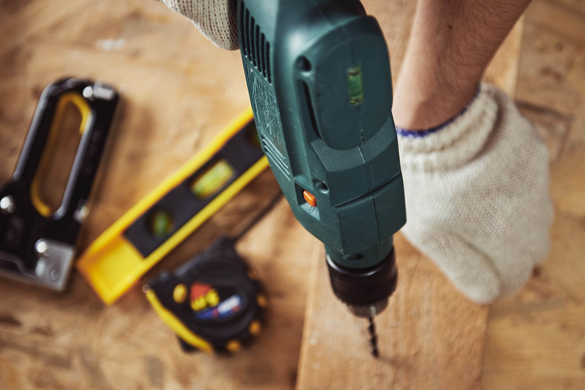 Carpenter working with wood and drill machine