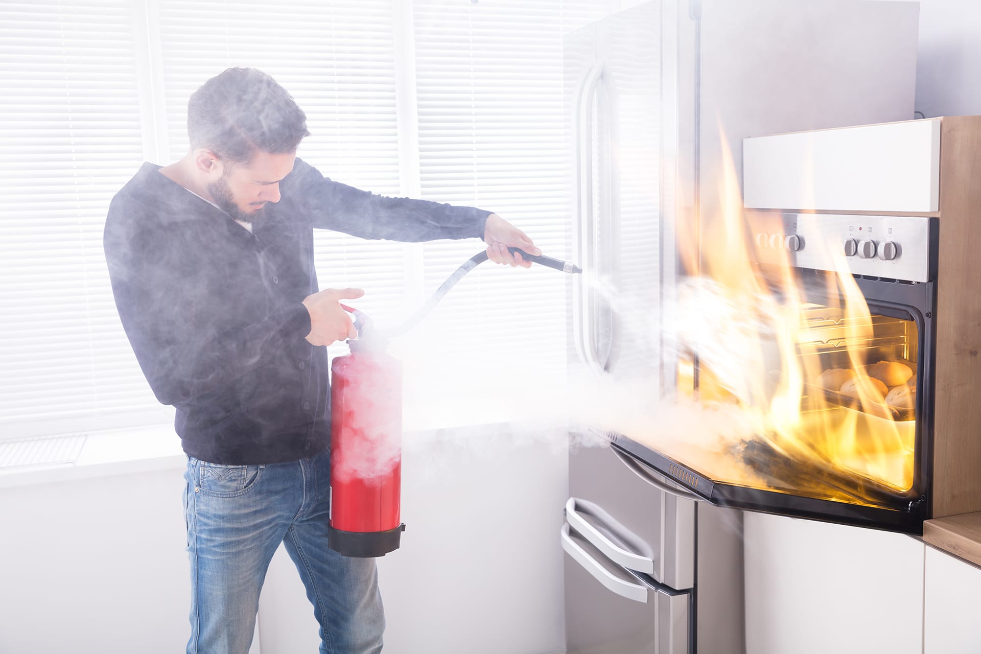 Men using fire extinguisher to stop fire